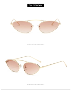 Detail view of gold metal oval sunglasses with brown gradient lenses and double bridge
