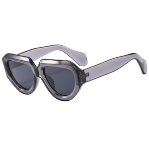 Modern oversized triangular geometric sunglasses with translucent grey frames and dark lenses