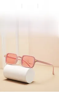 Detailed macro of pink square sunglasses with JH18201 model number and metal rivets