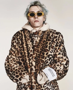 Close-up of leopard print faux fur coat featuring a thick hood and designer sleeve label