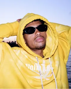 Close-up of retro black oval sunglasses with wide frames on a male model's face