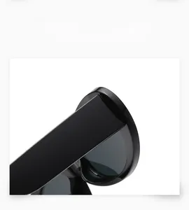 Detailed close-up of wide temple design and sturdy hinges on oval black sunglasses