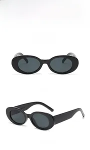 Detail view of retro oval sunglasses with thick black frames and dark grey lenses