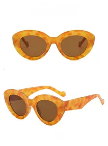 Detail view of oval leopard print sunglasses with brown lenses from front and side