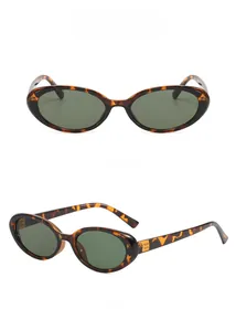 Detail of retro oval sunglasses featuring tortoiseshell frames and gold metal hinge accents