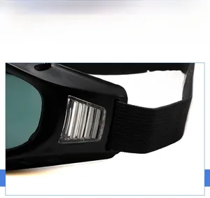 Detail view of adjustable black elastic strap and side vents on safety goggles