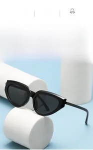 Close-up of black small cat eye sunglasses on white geometric display stand