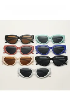 Flat lay of retro cat-eye sunglasses in seven trendy colors with thick frames