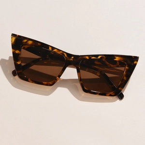 Close-up of tortoise shell cat-eye sunglasses with thick frames and brown lenses