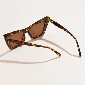Macro shot of tortoise shell cat-eye sunglasses with gradient brown lenses and frame details