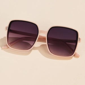 Detail of peach pink oversized sunglasses with metallic hinge decor and gradient lenses