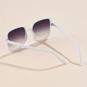 Detail view of white square oversized sunglasses with gradient lenses and metal hinges