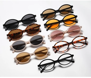 Flat lay of vintage oval sunglasses in various colors with printed temple specs