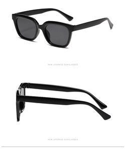 Detailed side view of classic black square sunglasses with glossy frames and dark lenses
