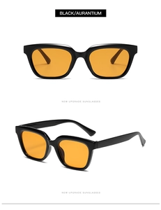 Detail view of small square black frame sunglasses with transparent orange lenses