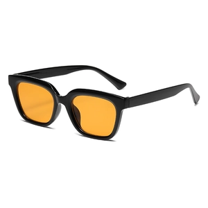 Retro small square black frame sunglasses with vibrant orange lenses for a street style look