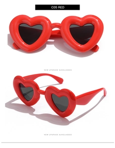 Gros plan de lunettes de soleil en forme de cœur rouge vif avec verres teintés foncés