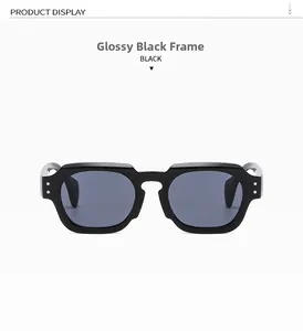 Close-up of shiny black square frame sunglasses with grey lenses and double metal rivets