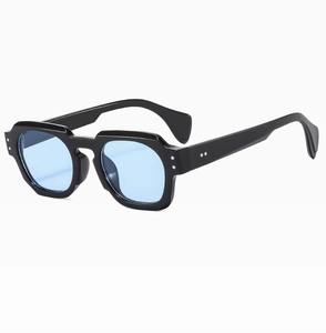 Detail view of polygon sunglasses with black frames, light blue lenses, and silver rivets