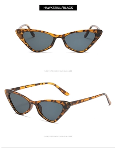Close-up of retro hawksbill cat-eye sunglasses with slim frames and dark lenses