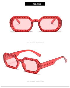 Macro detail of red jelly sunglasses with octagon frames and sparkling rhinestones