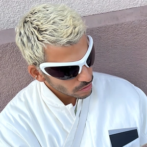 Close-up of white Y2K futuristic wrap-around sunglasses with a sleek cat-eye design