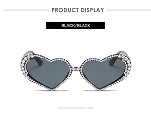 Detailed front view of black heart-shaped sunglasses with colorful rhinestone accents