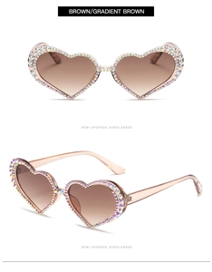 Detail view of heart-shaped sunglasses featuring AB rhinestones and brown gradient lenses
