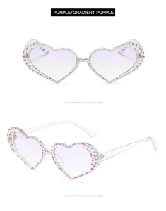 Close-up of heart-shaped sunglasses with purple gradient lenses and AB rhinestones