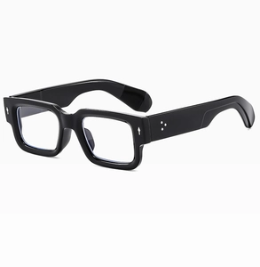Detail view of thick black square sunglasses frame with silver rivets and sleek finish