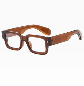 Macro view of retro thick amber PC frame sunglasses with silver rivet decoration details