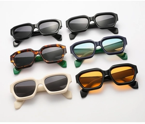 Flat lay of multiple retro chunky polygon sunglasses in diverse colors on white background