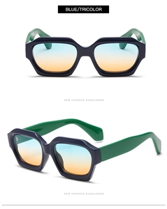 Detail view of thick blue frame sunglasses with tri-color gradient lenses and green temples