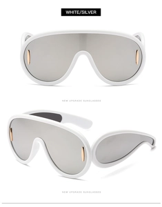 Dettaglio macro degli occhiali da sole a maschera bianchi e argento in stile futuristico Y2K