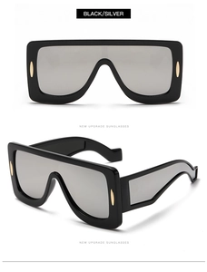 Detail of oversized shield sunglasses with black frame and silver mirrored lenses