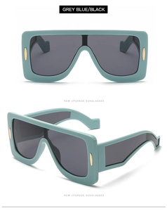 Detail of grey blue oversized square sunglasses with matte finish and gold rivets