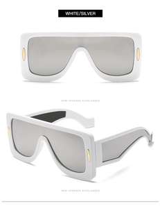 Detail view of white oversized sunglasses with silver mirrored lenses and gold accents