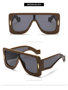 Detailed views of oversized brown square sunglasses with gold accents and dark lenses