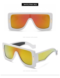 Detail of oversized white square frame sunglasses with orange gradient reflective lenses