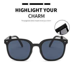 Detail of square oversized sunglasses with chic metal rivets and sturdy hinge texture