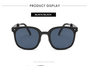 Detailed display of classic black oversized sunglasses with metallic stud embellishments