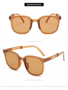 Detail view of foldable brown sunglasses with resin frames and metal hinges