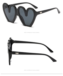Detail der schwarzen Herz-Sonnenbrille mit Kunststoffrahmen und silbernen Metallelementen