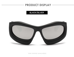 Detail of Y2K shield sunglasses with thick matte black frame and silver mirrored lens