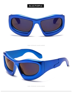 Detail view of bold metallic blue Y2K wraparound sunglasses with dark tinted lenses