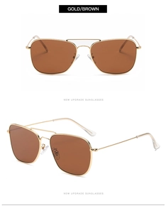 Détail de lunettes pilote en métal doré avec verres bruns et structure à double pont