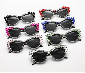 Cat eye sunglasses detail showing multiple colors and rhinestone-encrusted plastic frames