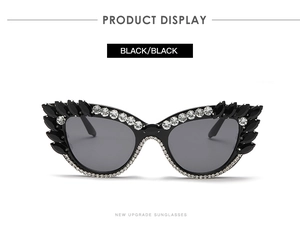 Close-up of cat-eye sunglasses with rhinestone edges and black water-drop accents