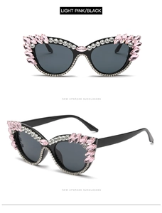 Detail of cat eye sunglasses with black frame and pink marquise rhinestones