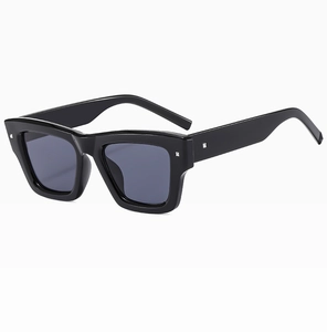 Detail shot of black square frame sunglasses with silver stud accents and grey lenses